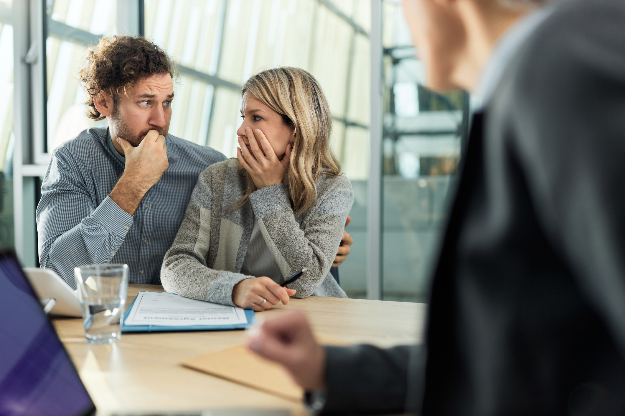 Worried couple having a meeting with insurance agent in the office.