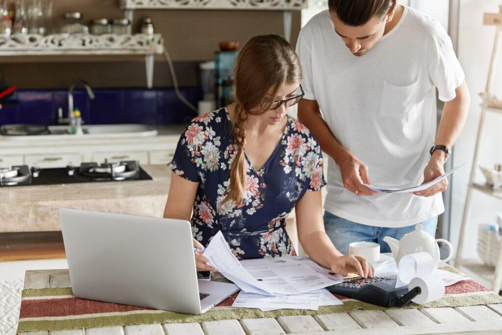 Shot of European couple doing paperwork for selling their home