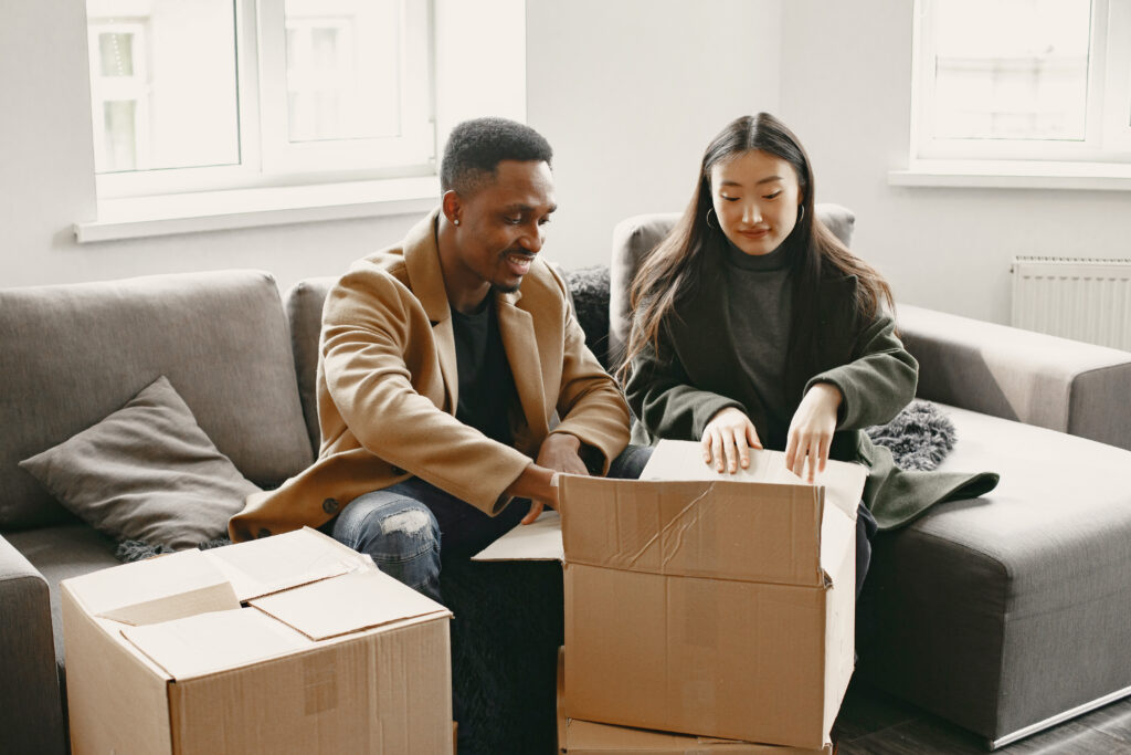 Couple unpacking boxes at their new home
